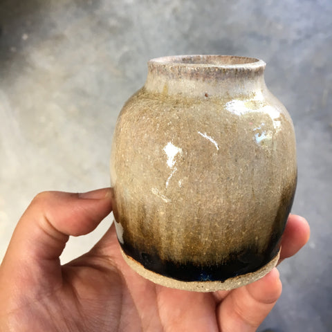 A thrown and glazed handmade pottery vase